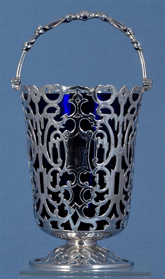 An early Victorian silver swing handled sugar basket and blue glass liner, Height: to handle 7 ¾”/195mm Top Dia 4”/100mm